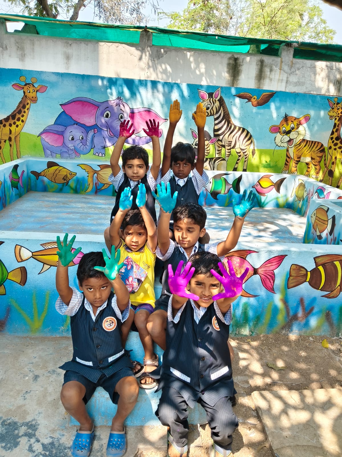 Children showing colourful painted hands
