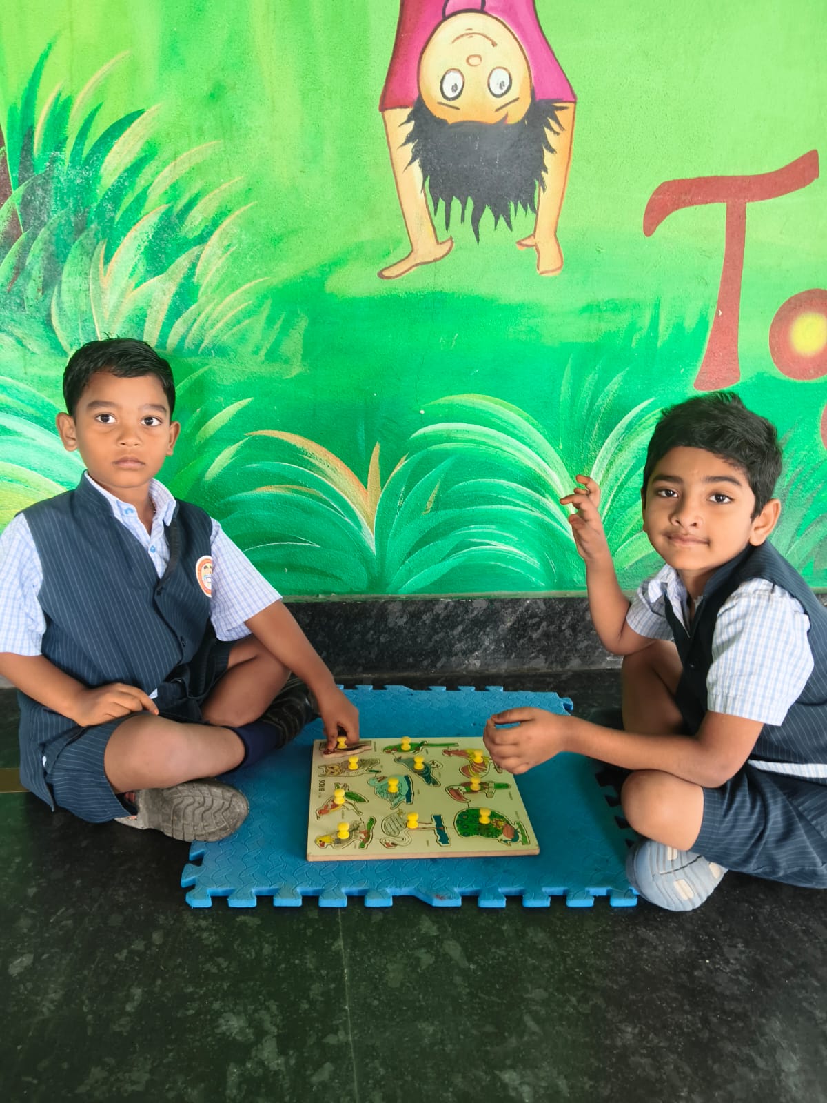 Two students solving a wooden puzzle