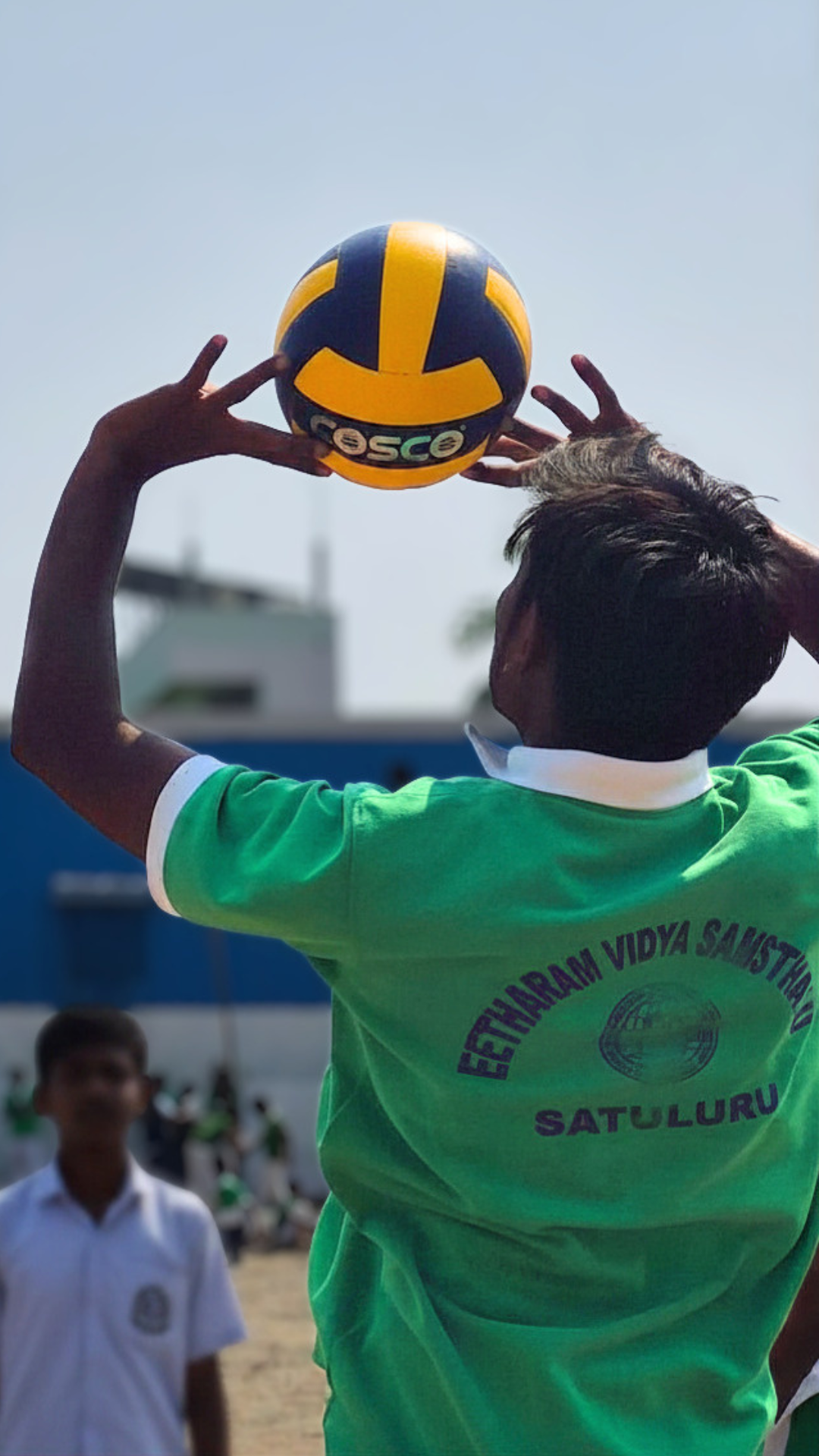 Student serving a volleyball