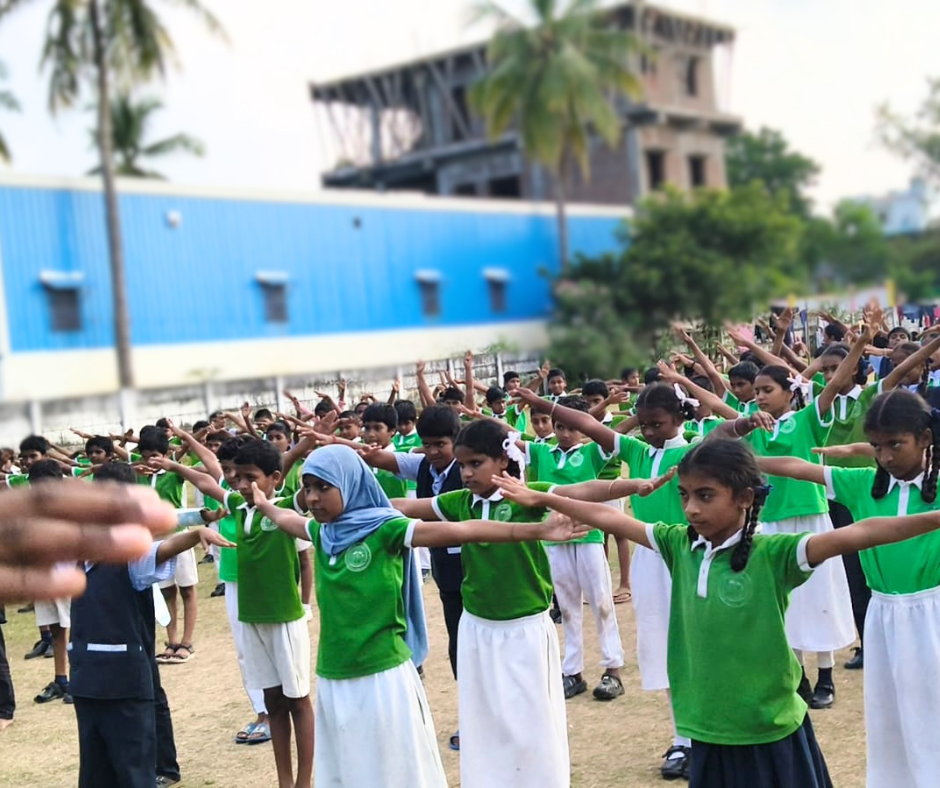 Students performing yoga in the school ground